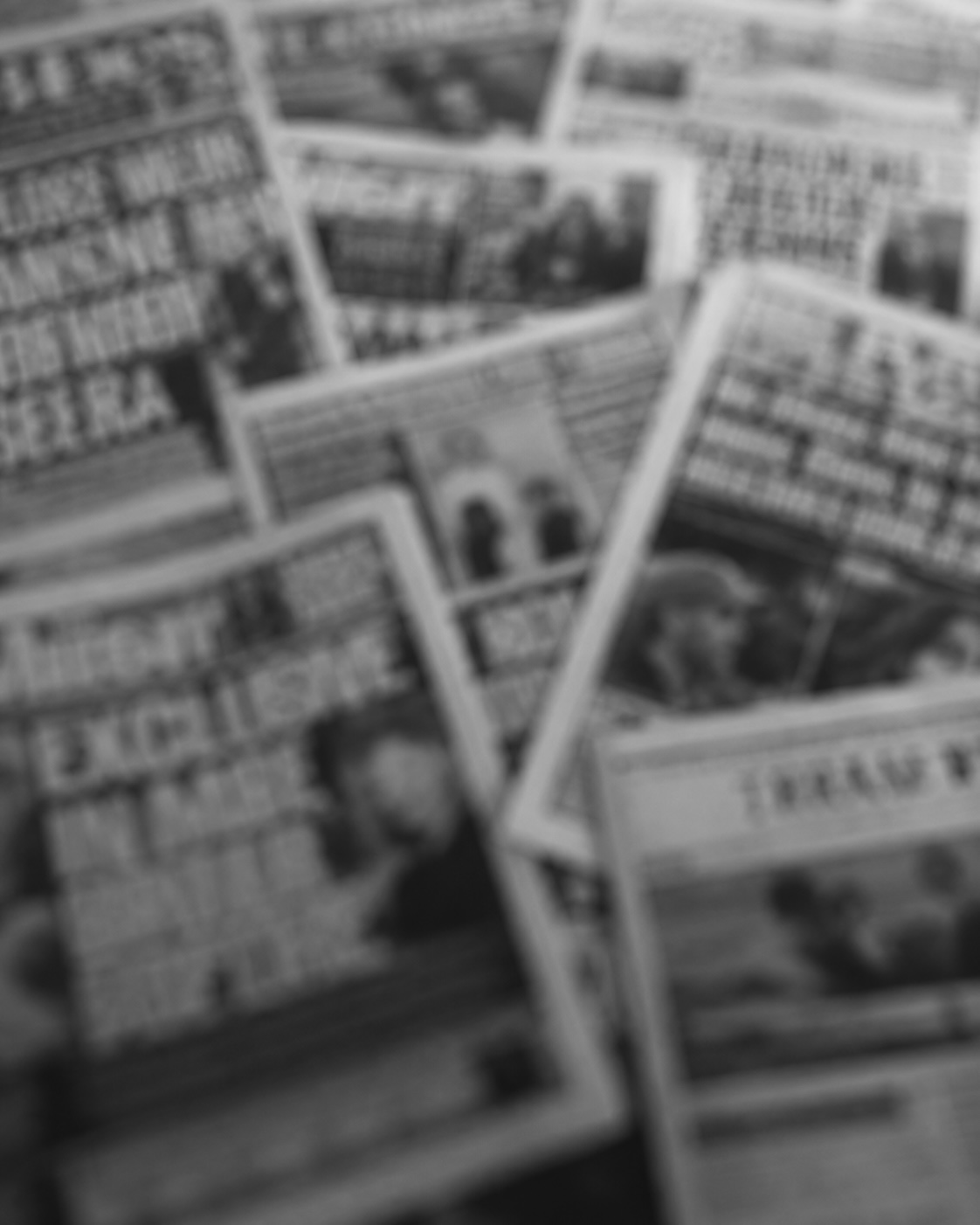 Newspaper front pages spread out and blurred representing Reputation Intelligence